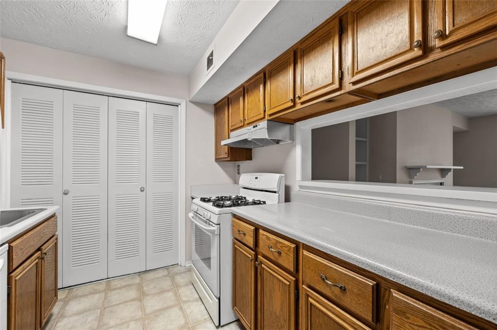 1004 Dunbar Drive Atlanta, GA 30338 - Photo 11 of 23 a kitchen with stainless steel appliances granite countertop a stove and a sink