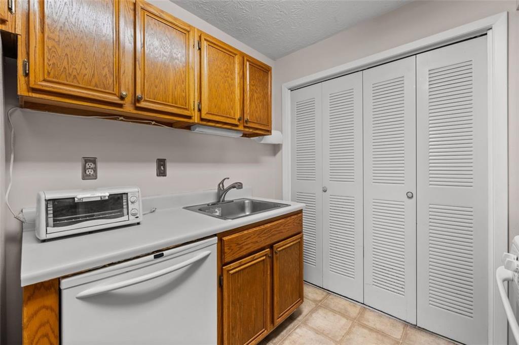 1004 Dunbar Drive Atlanta, GA 30338 - Photo 12 of 23 a kitchen with stainless steel appliances granite countertop a sink and cabinets