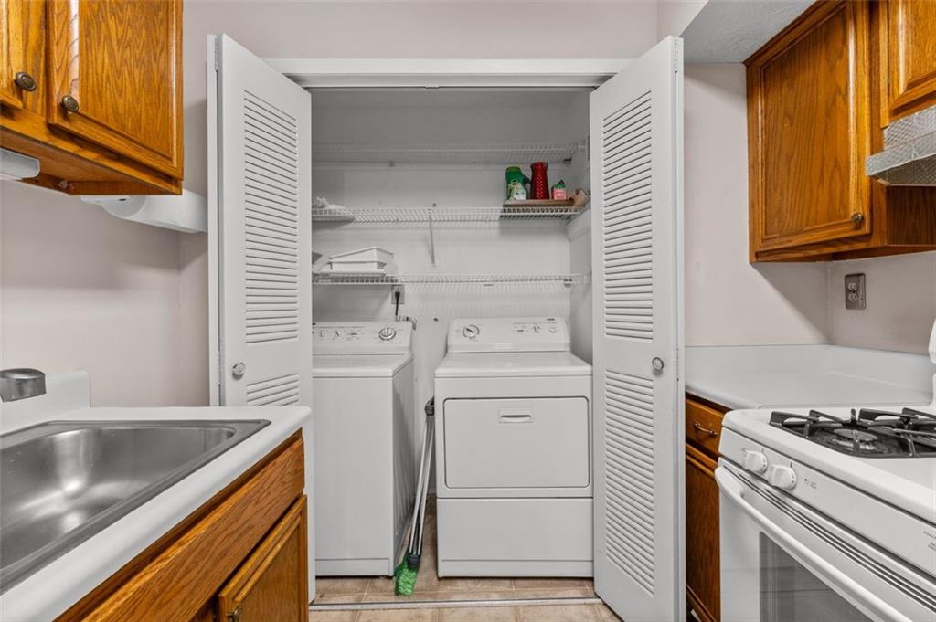 1004 Dunbar Drive Atlanta, GA 30338 - Photo 13 of 23 a kitchen with a sink stove and cabinets