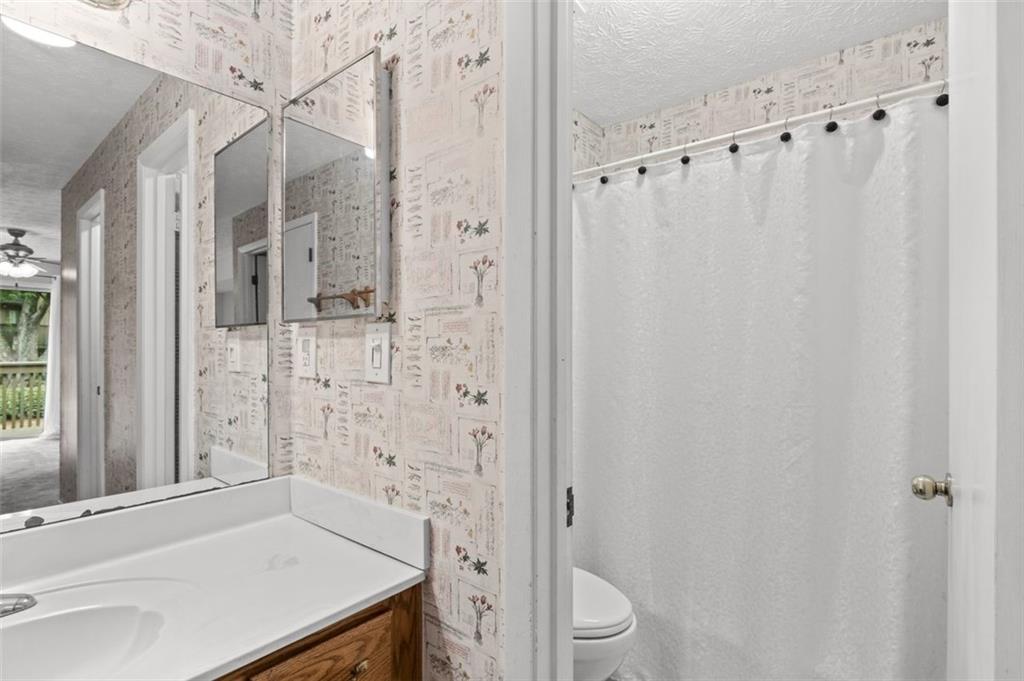 1004 Dunbar Drive Atlanta, GA 30338 - Photo 21 of 23 a bathroom with a sink a toilet and shower