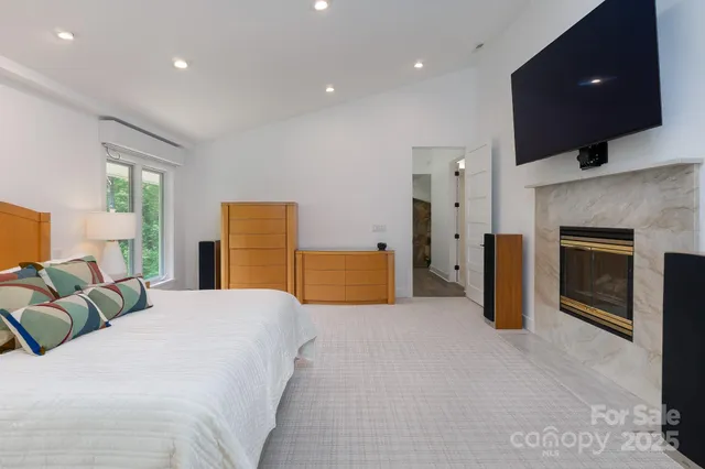 a spacious bedroom with a bed and a television