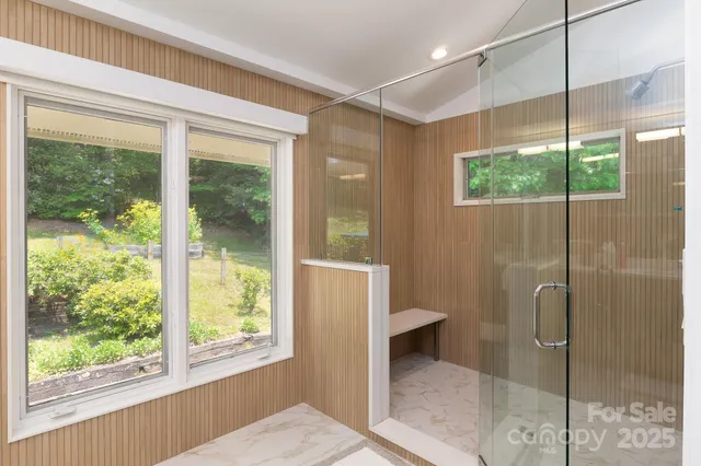 a bathroom with a glass shower door