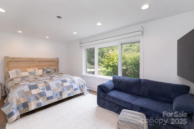 a bedroom with a bed window and couch