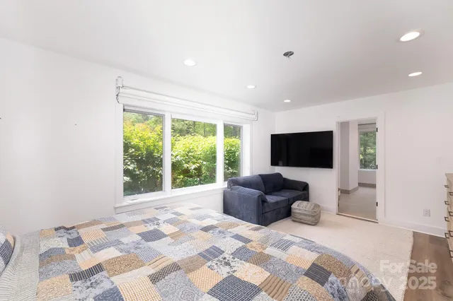 a bedroom with a bed and a television