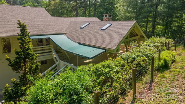 a aerial view of a house with a yard and potted plants