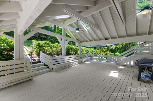 an aerial view of a house with yard and large trees