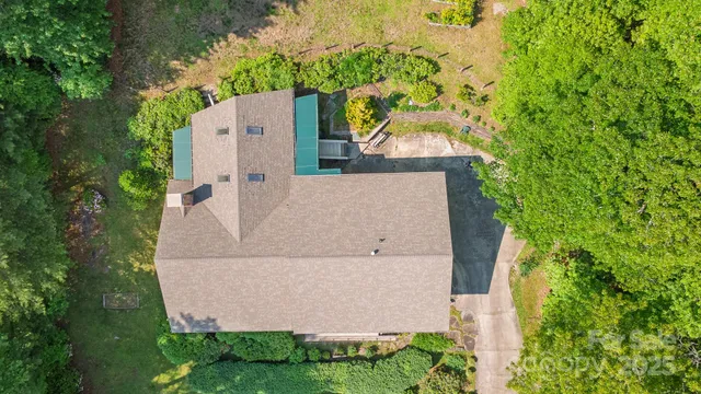 an aerial view of a house with a yard