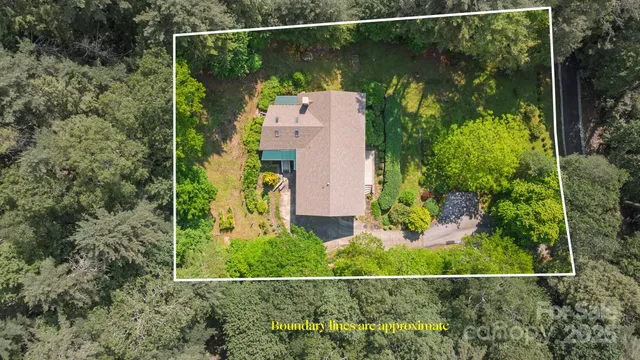 an aerial view of a house with a yard and garden