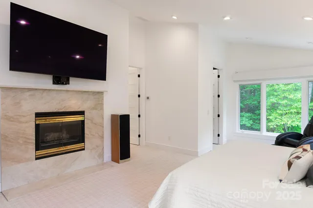 a bedroom with a bed and a television