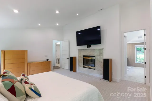 a bedroom with a bed and a television