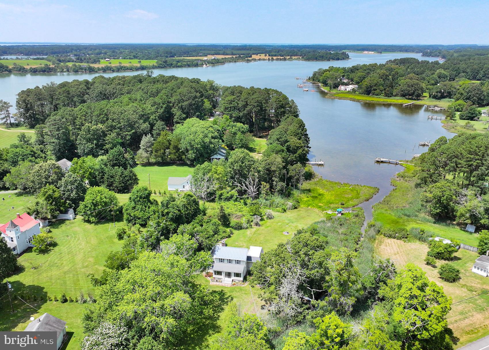8000 Bozman Neavitt Road St. Michaels, MD 21663 - Photo 2 of 57 an aerial view of a houses with a yard and lake view