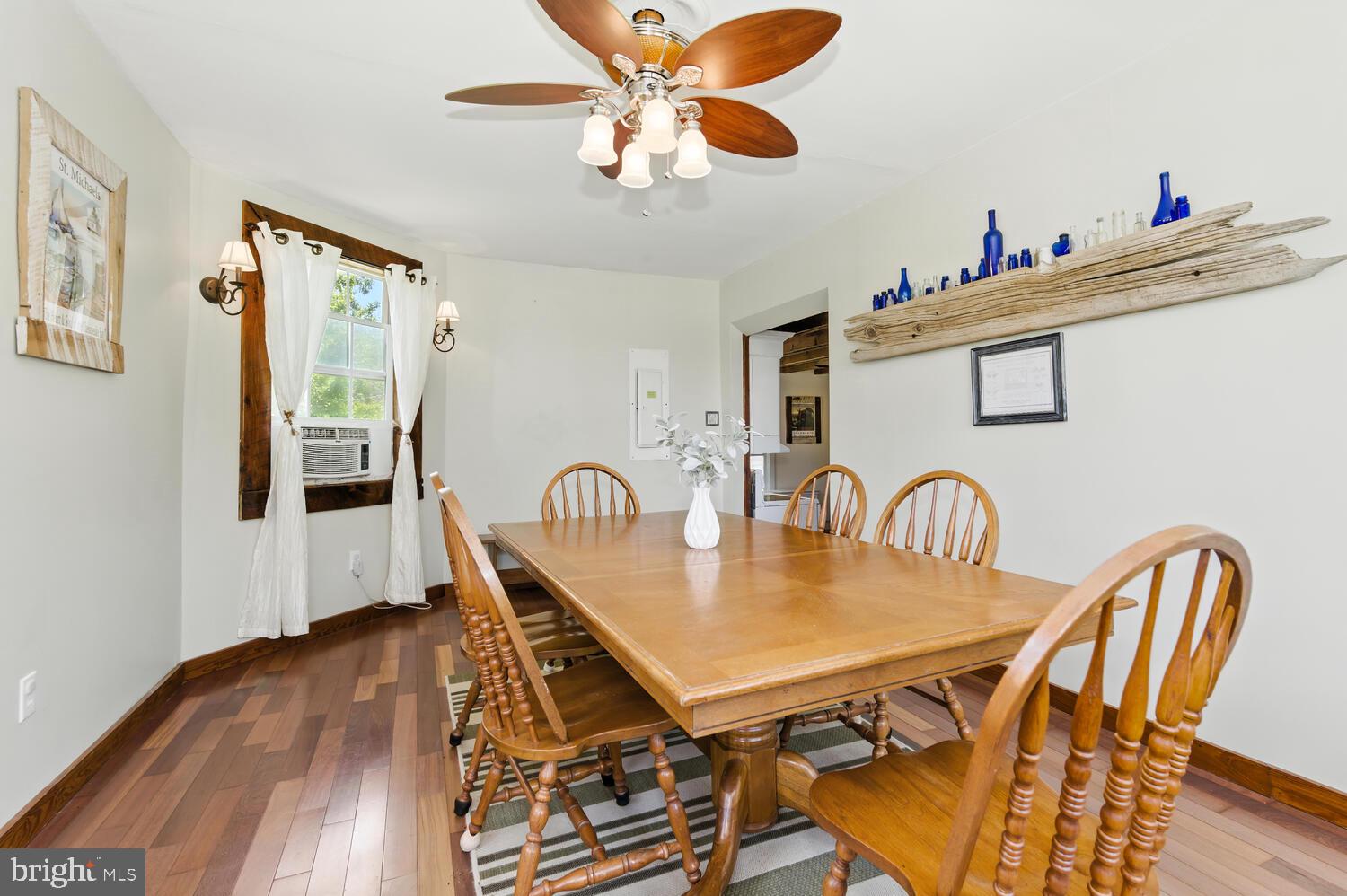 8000 Bozman Neavitt Road St. Michaels, MD 21663 - Photo 34 of 57 a dining room with furniture a chandelier and wooden floor