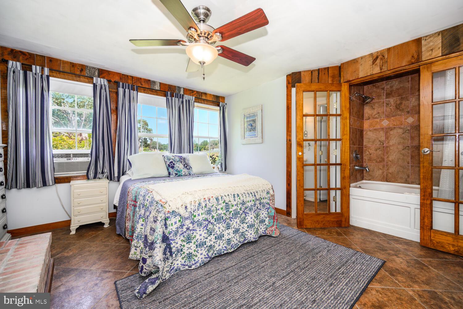 8000 Bozman Neavitt Road St. Michaels, MD 21663 - Photo 36 of 57 a bedroom with a large bed and a chandelier