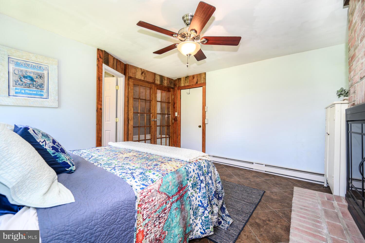 8000 Bozman Neavitt Road St. Michaels, MD 21663 - Photo 37 of 57 a bedroom with a bed and a large window