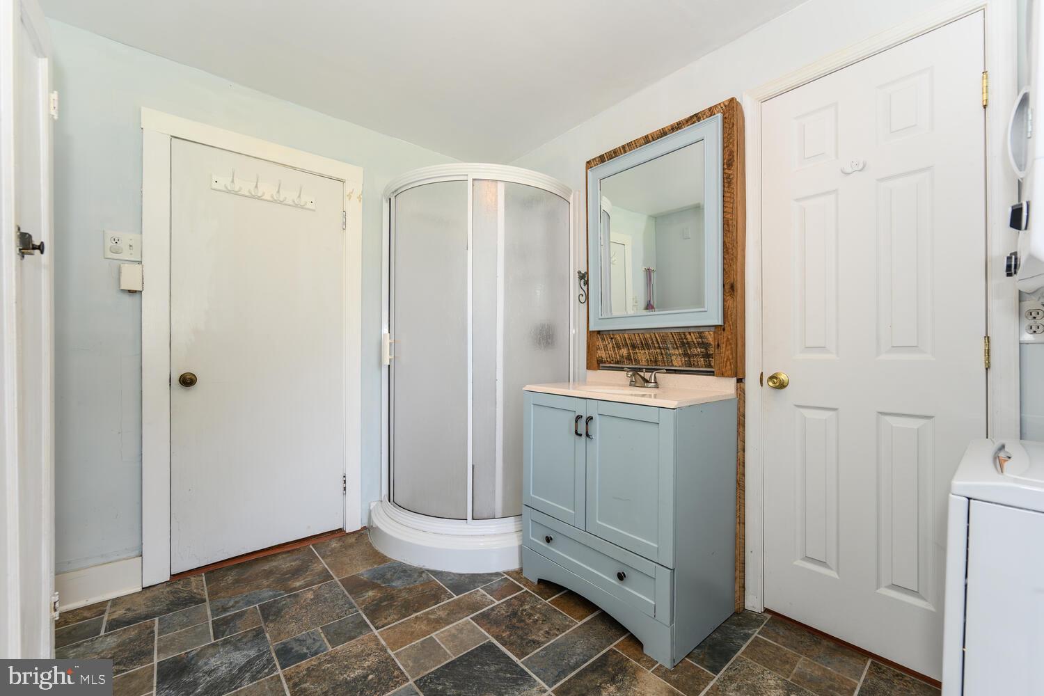 8000 Bozman Neavitt Road St. Michaels, MD 21663 - Photo 40 of 57 a bathroom with a sink and a mirror