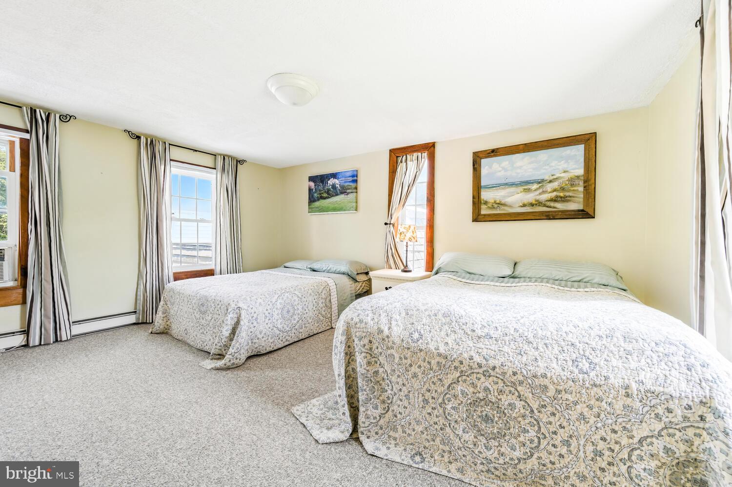 8000 Bozman Neavitt Road St. Michaels, MD 21663 - Photo 42 of 57 a spacious bedroom with two beds and a window