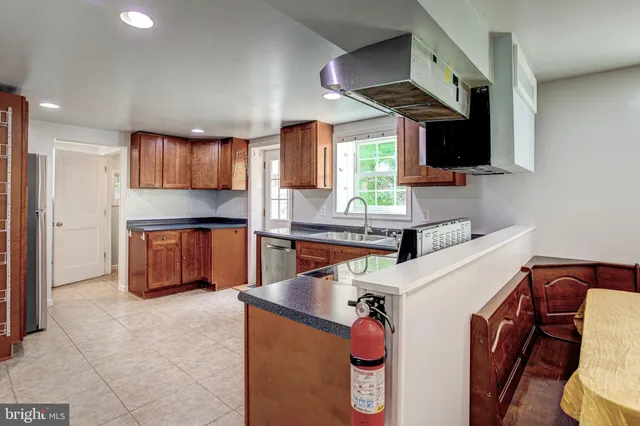 a kitchen with stainless steel appliances granite countertop a sink and a stove