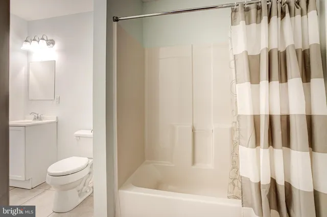a bathroom with a toilet and a bathtub