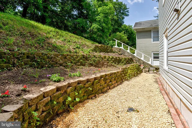 a view of a yard with wooden fence