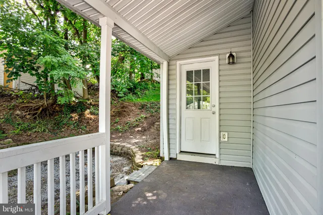 a view of a porch with wooden floor and roof with floor to ceiling window
