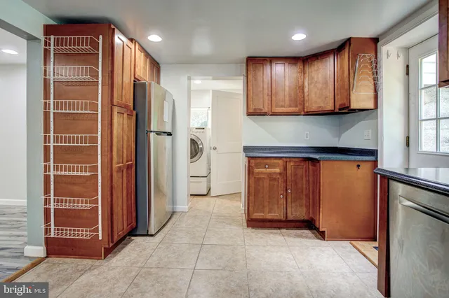 a view of a kitchen with an entryway and a window
