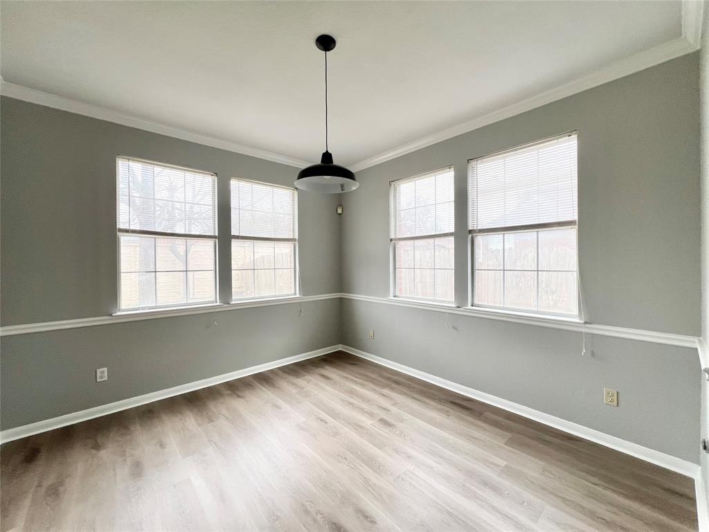 1809 Springwater Drive Round Rock, TX 78681 - Photo 5 of 25 Unfurnished dining area featuring crown molding, light wood finished floors, and plenty of natural light