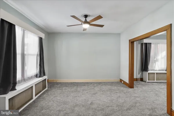a view of empty room with ceiling fan