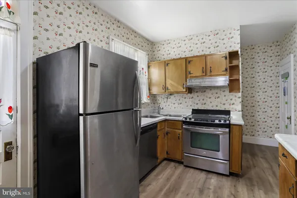 a kitchen with a refrigerator sink and stove