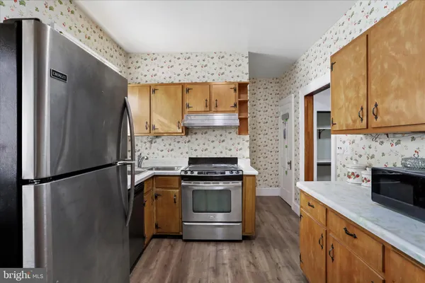 a kitchen with a refrigerator sink and stove