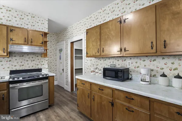 a kitchen with stainless steel appliances a stove a microwave and cabinets