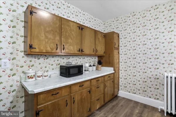 a kitchen with a sink a stove and a microwave oven