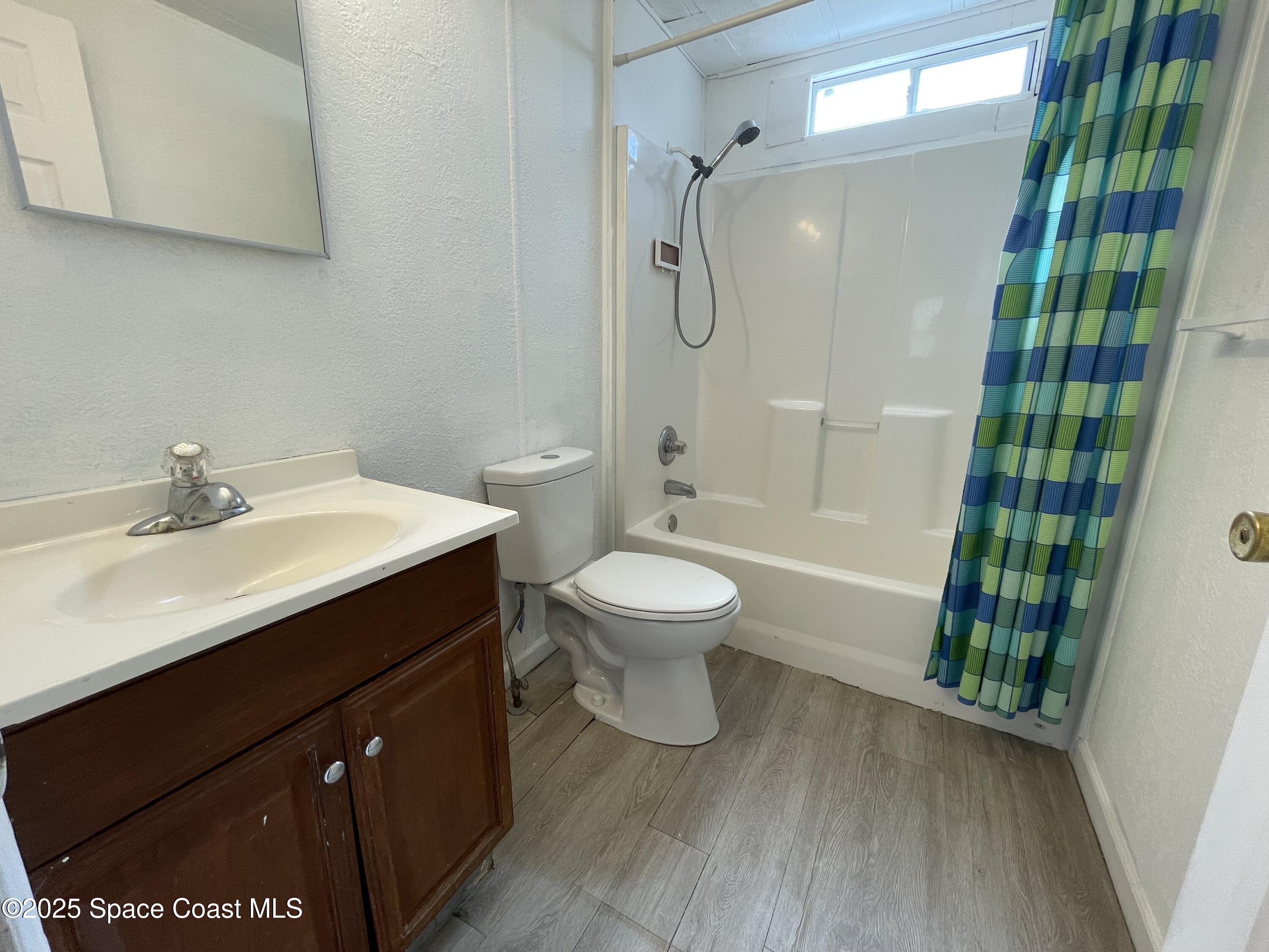 7002 Ash Drive Cocoa, FL 32927 - Photo 11 of 17 a bathroom with a sink toilet and shower