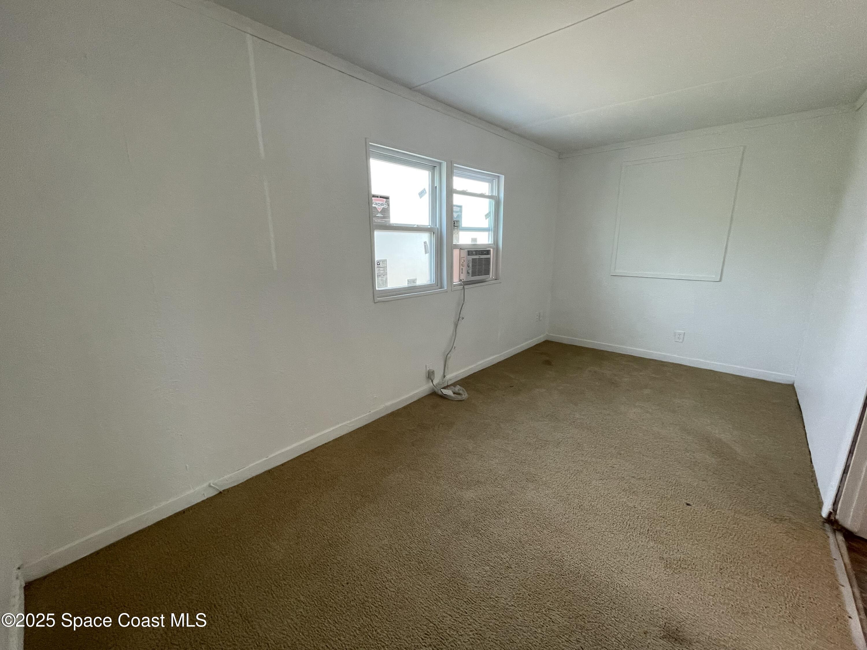 7002 Ash Drive Cocoa, FL 32927 - Photo 13 of 17 an empty room with windows
