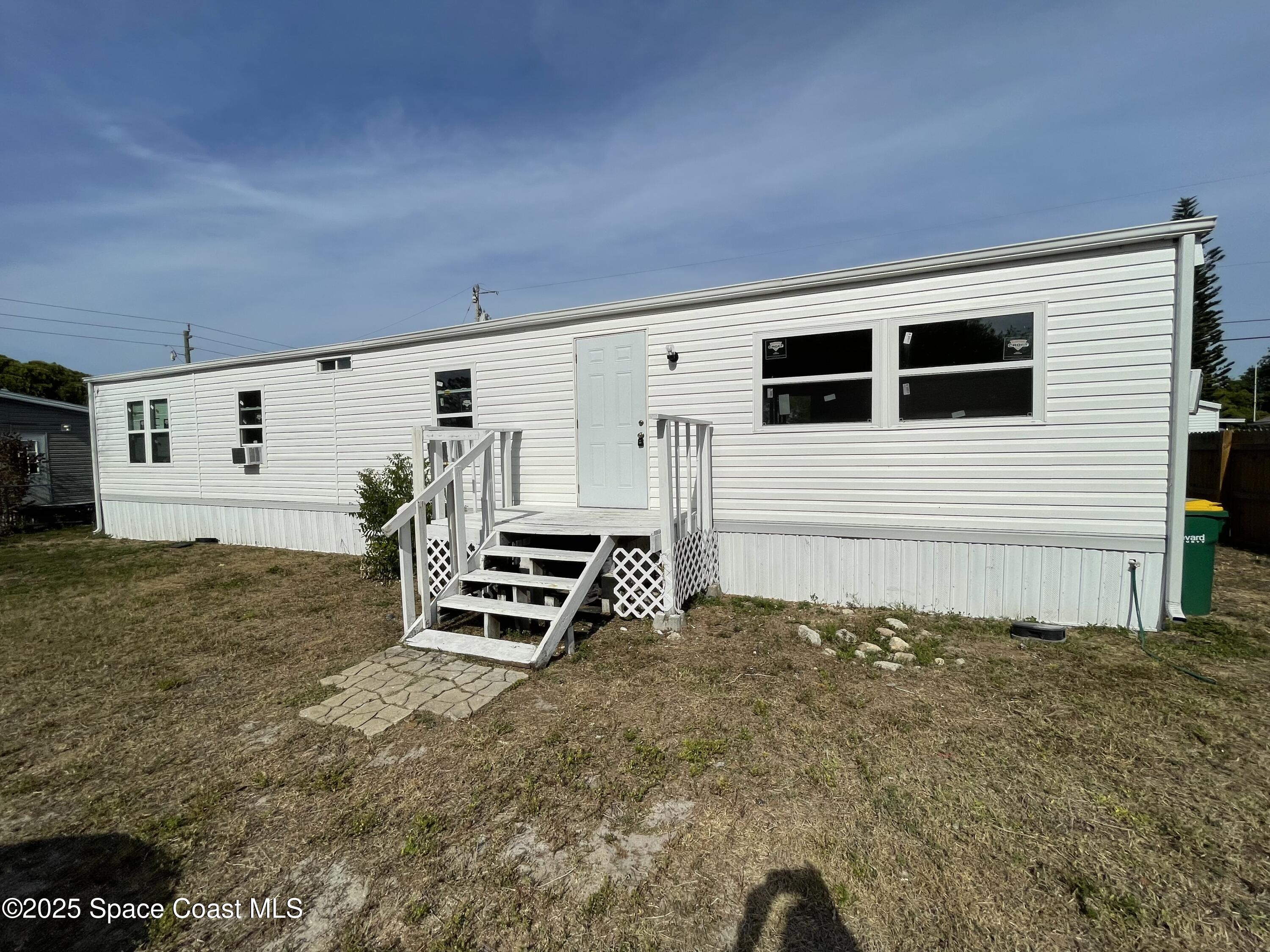 7002 Ash Drive Cocoa, FL 32927 - Photo 17 of 17 a view of a house with a backyard