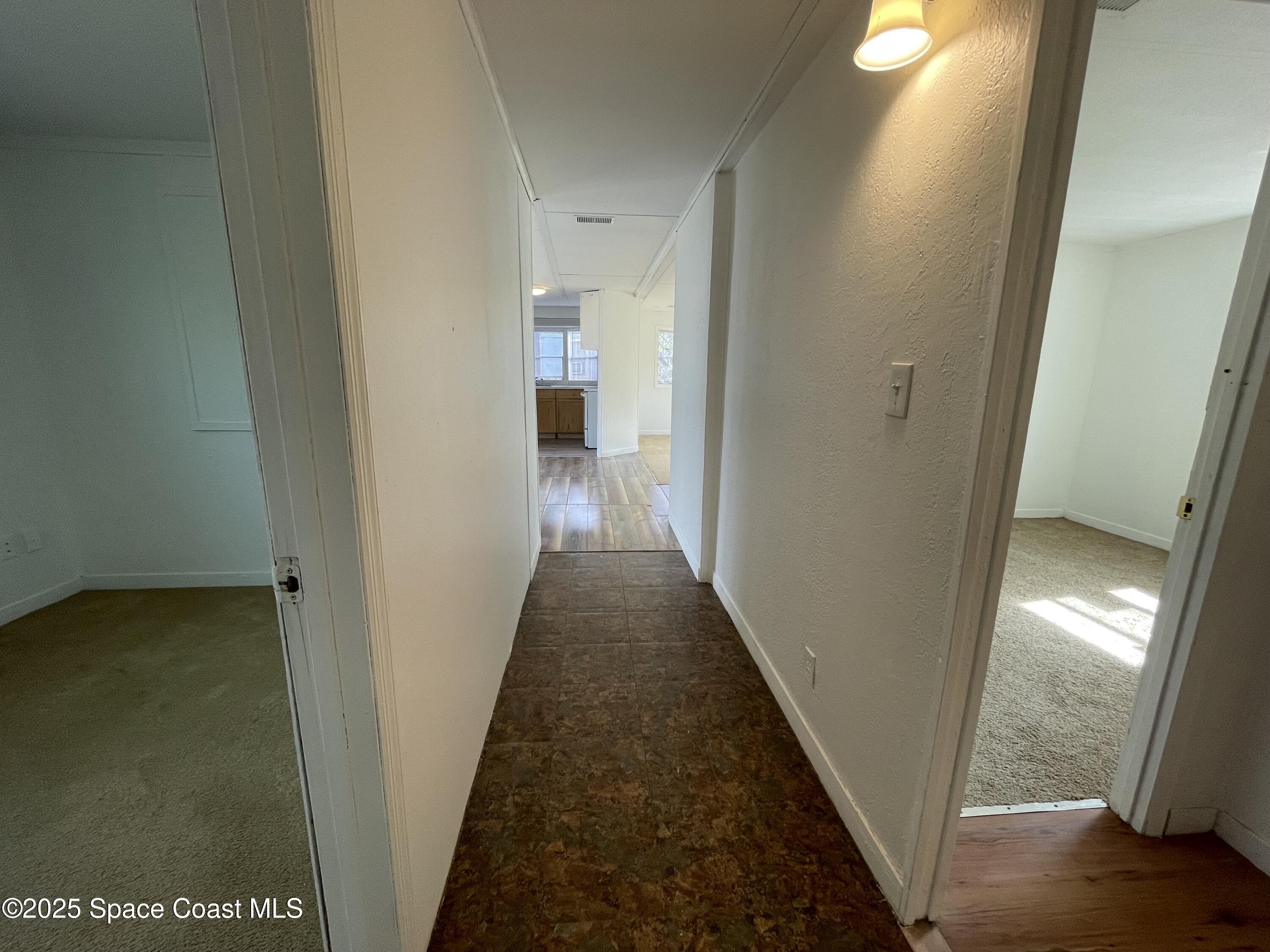 7002 Ash Drive Cocoa, FL 32927 - Photo 8 of 17 a view of a hallway with wooden floor