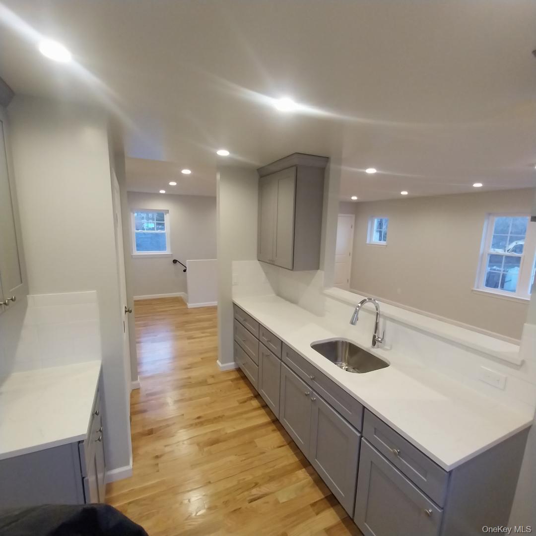 343 Jackson Street, Unit 5 Hempstead, NY 11550 - Photo 4 of 16 Kitchen featuring gray cabinets, light wood finished floors, light stone countertops, and recessed lighting