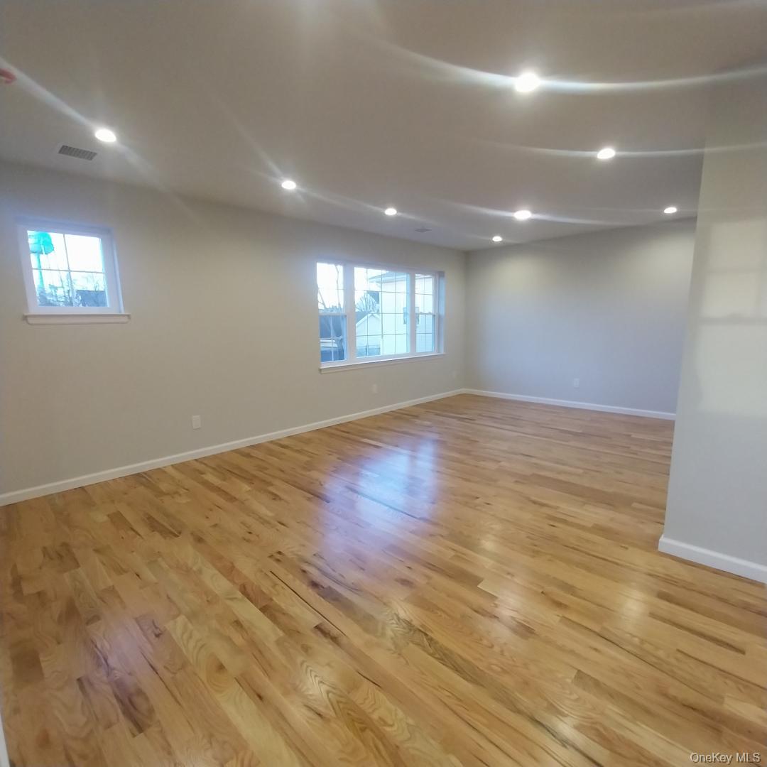 343 Jackson Street, Unit 5 Hempstead, NY 11550 - Photo 8 of 16 Below grade area featuring light wood finished floors, plenty of natural light, and recessed lighting