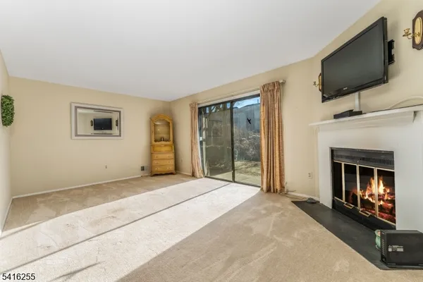 a view of a livingroom with an empty space and a fireplace