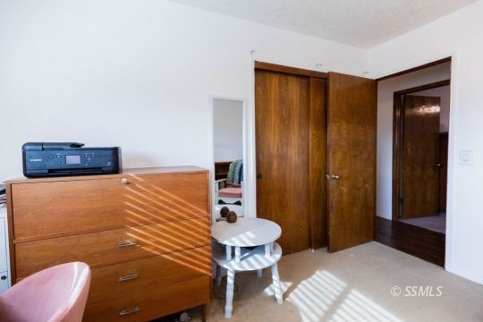 348 South Locust Street Ridgecrest, CA 93555 - Photo 10 of 21 a bedroom with a bed and a chair
