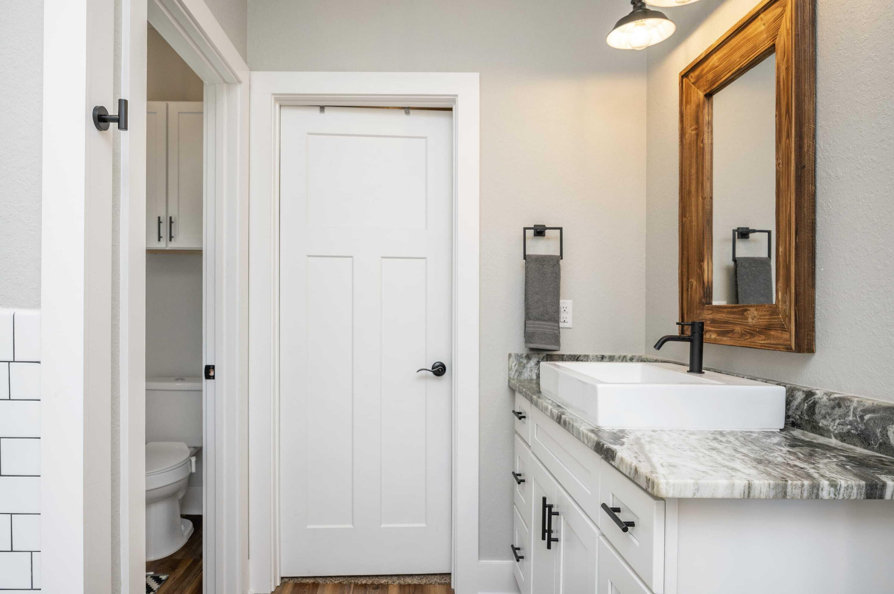 8151 Tommy Steele Road Baker, FL 32531 - Photo 15 of 36 a bathroom with a granite countertop sink and a mirror
