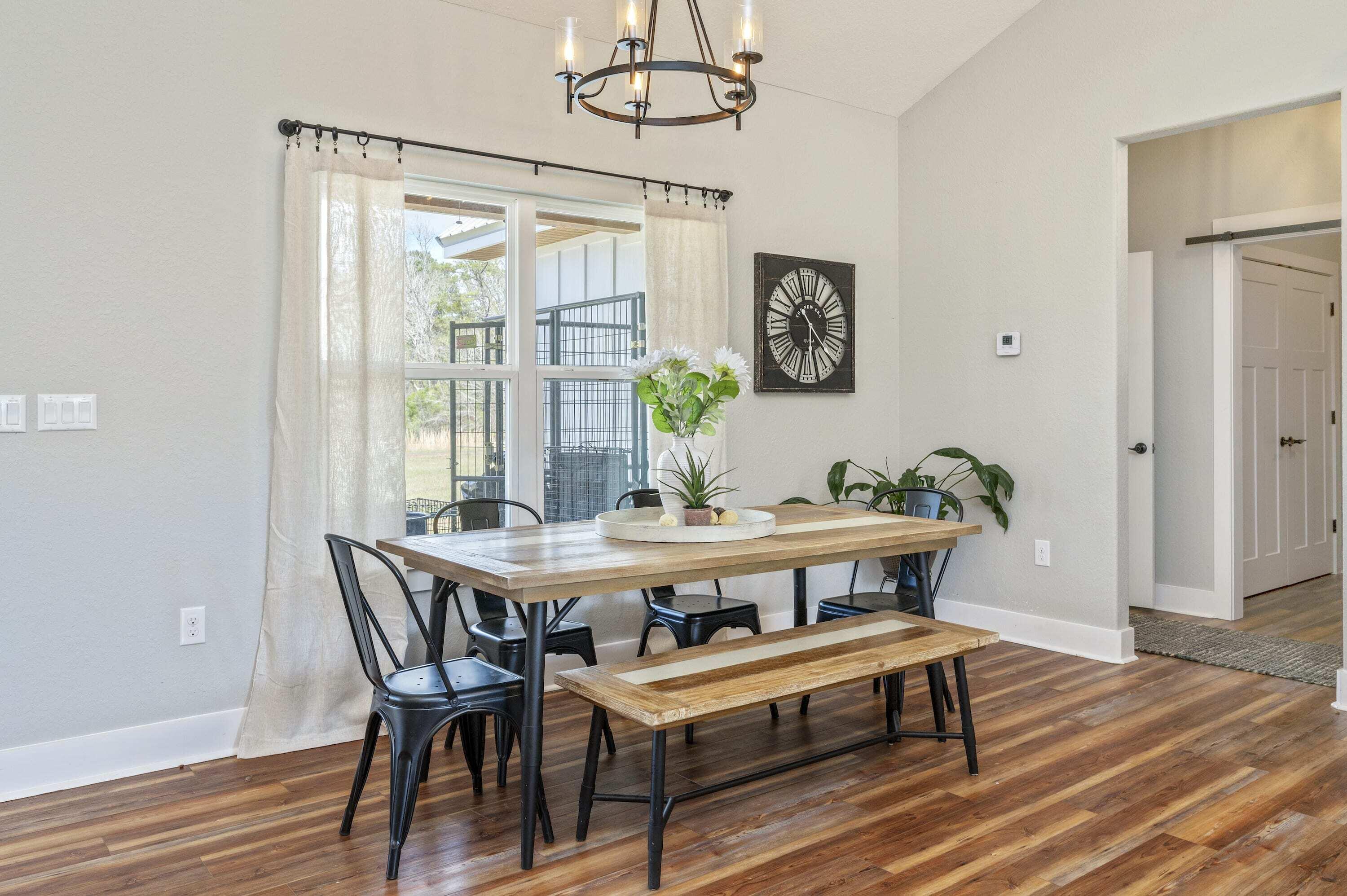 8151 Tommy Steele Road Baker, FL 32531 - Photo 20 of 36 a view of a dining room with furniture window and wooden floor