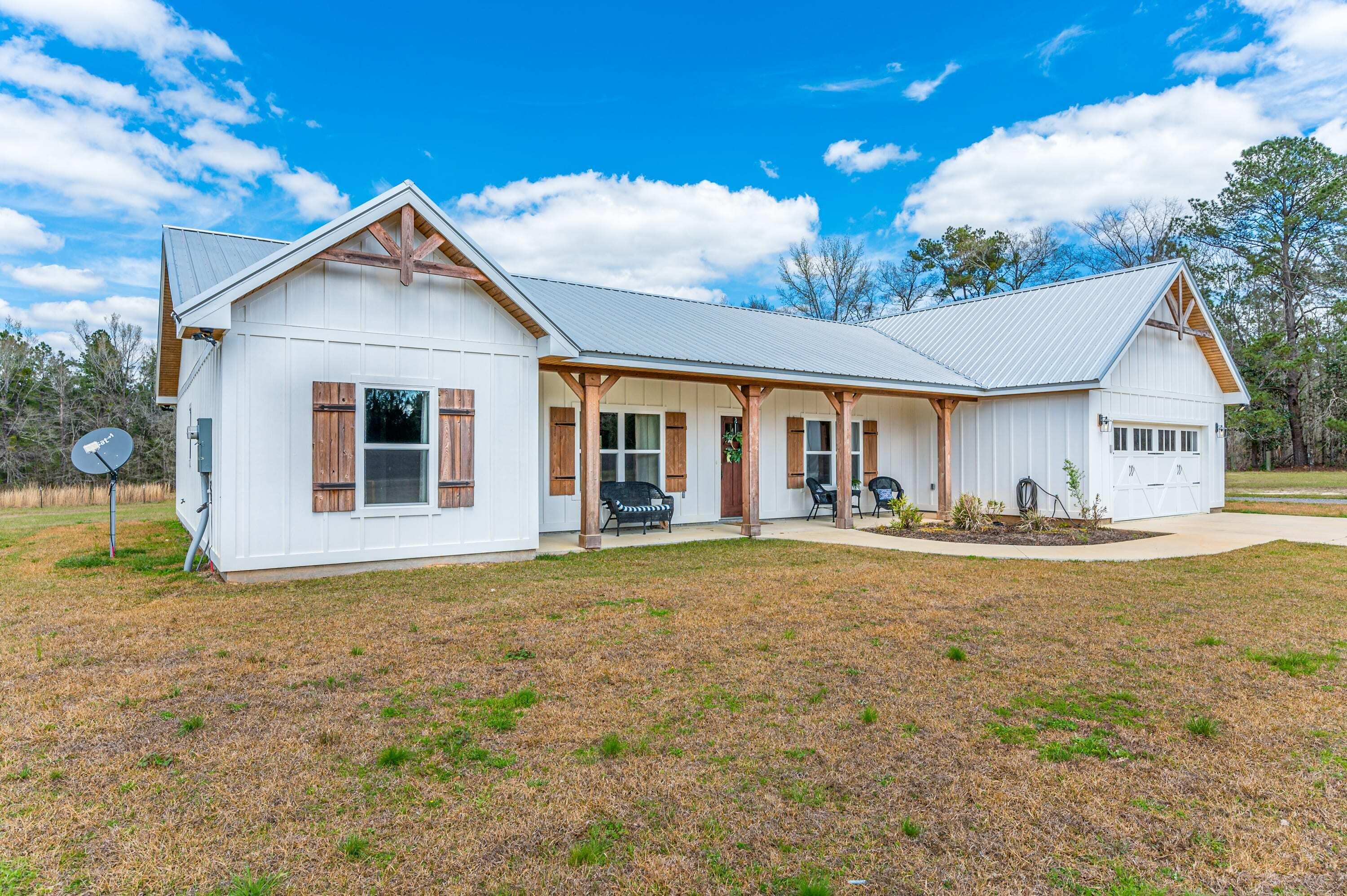 8151 Tommy Steele Road Baker, FL 32531 - Photo 2 of 36 a front view of house with yard and trees in the background