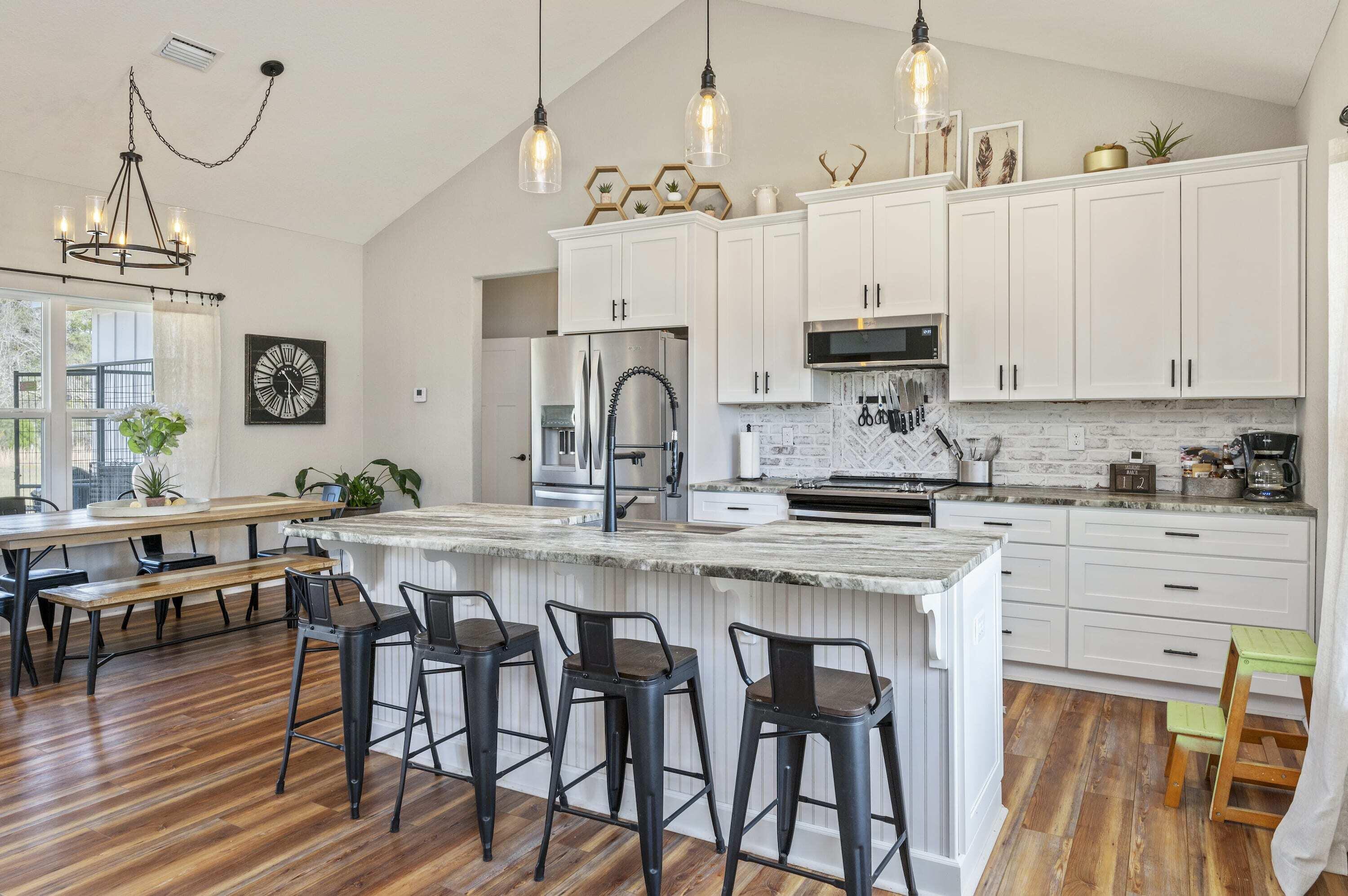 8151 Tommy Steele Road Baker, FL 32531 - Photo 23 of 36 a kitchen with stainless steel appliances granite countertop a white cabinets and a stove top oven