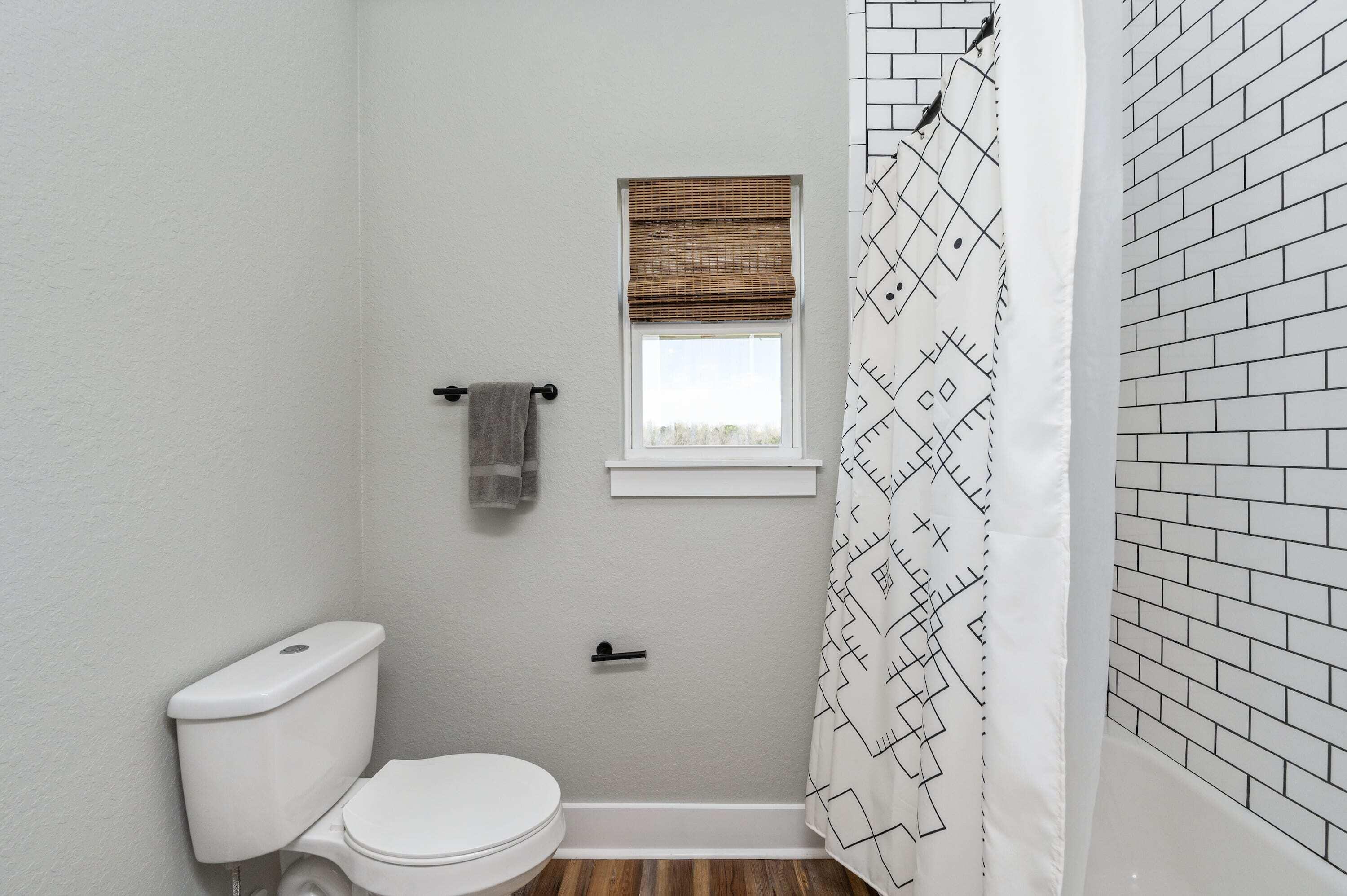 8151 Tommy Steele Road Baker, FL 32531 - Photo 30 of 36 a white toilet sitting next to a shower curtain