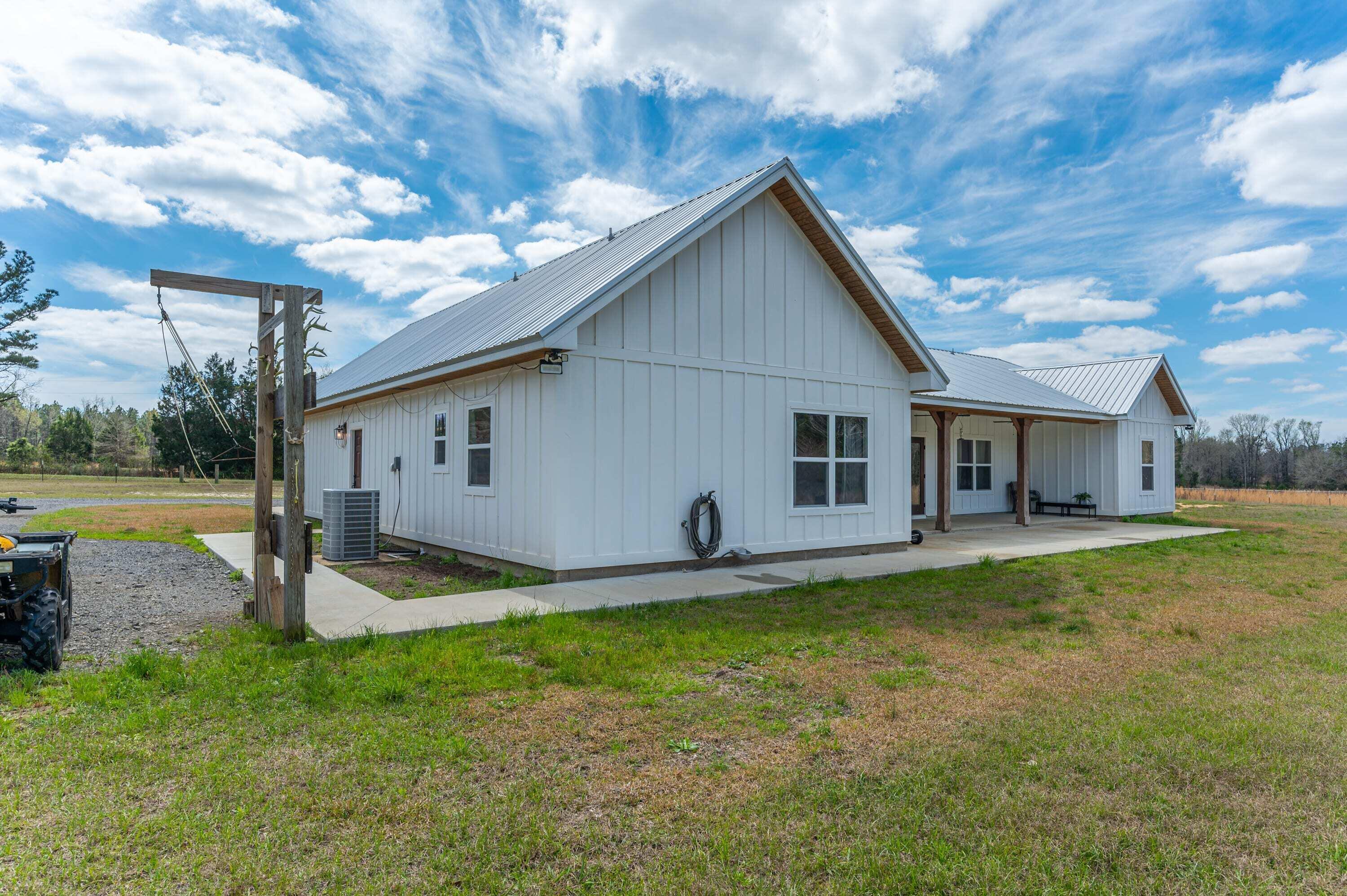 8151 Tommy Steele Road Baker, FL 32531 - Photo 7 of 36 a front view of house with yard and outdoor seating