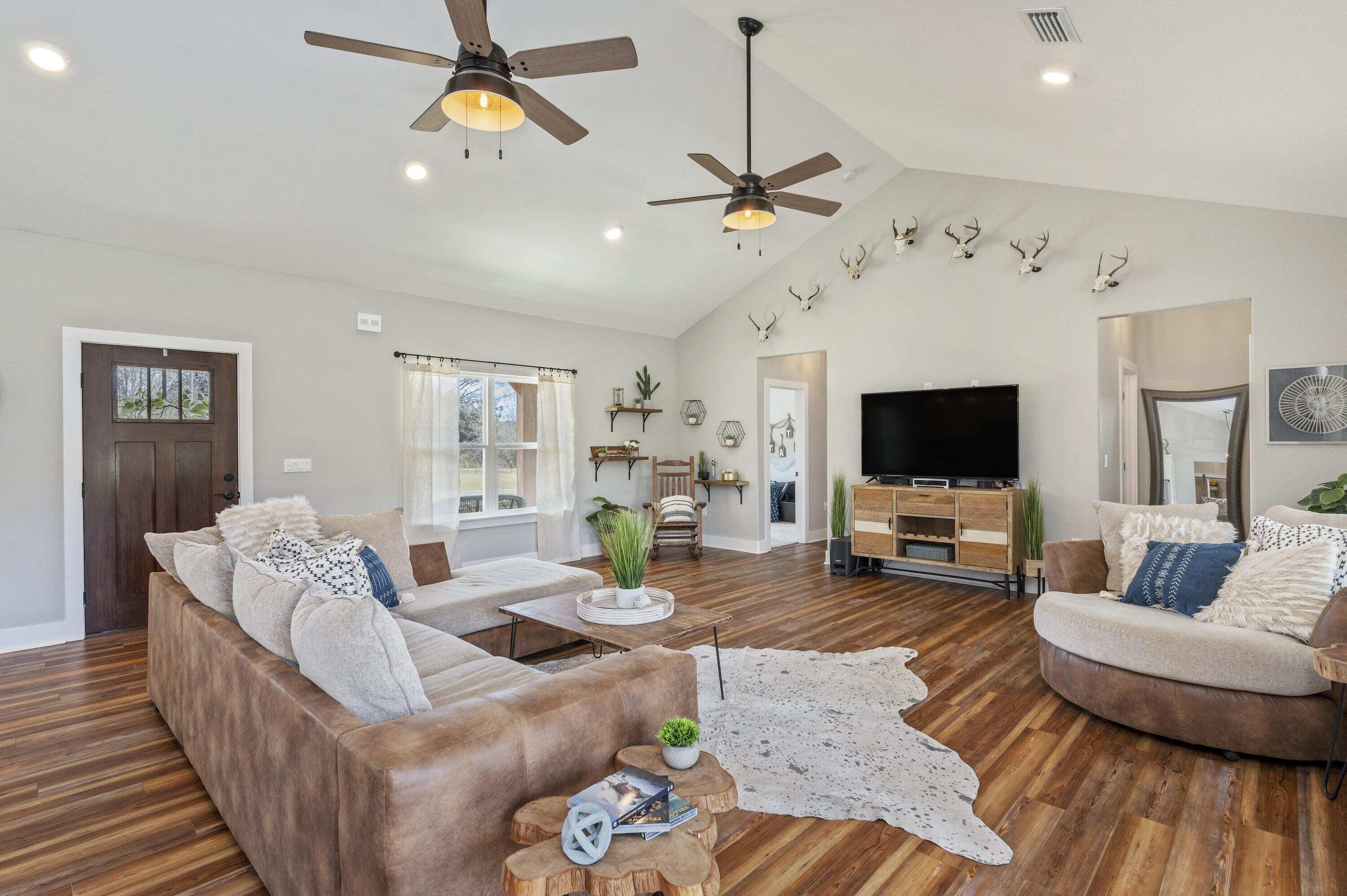 8151 Tommy Steele Road Baker, FL 32531 - Photo 8 of 36 a living room with furniture and a flat screen tv