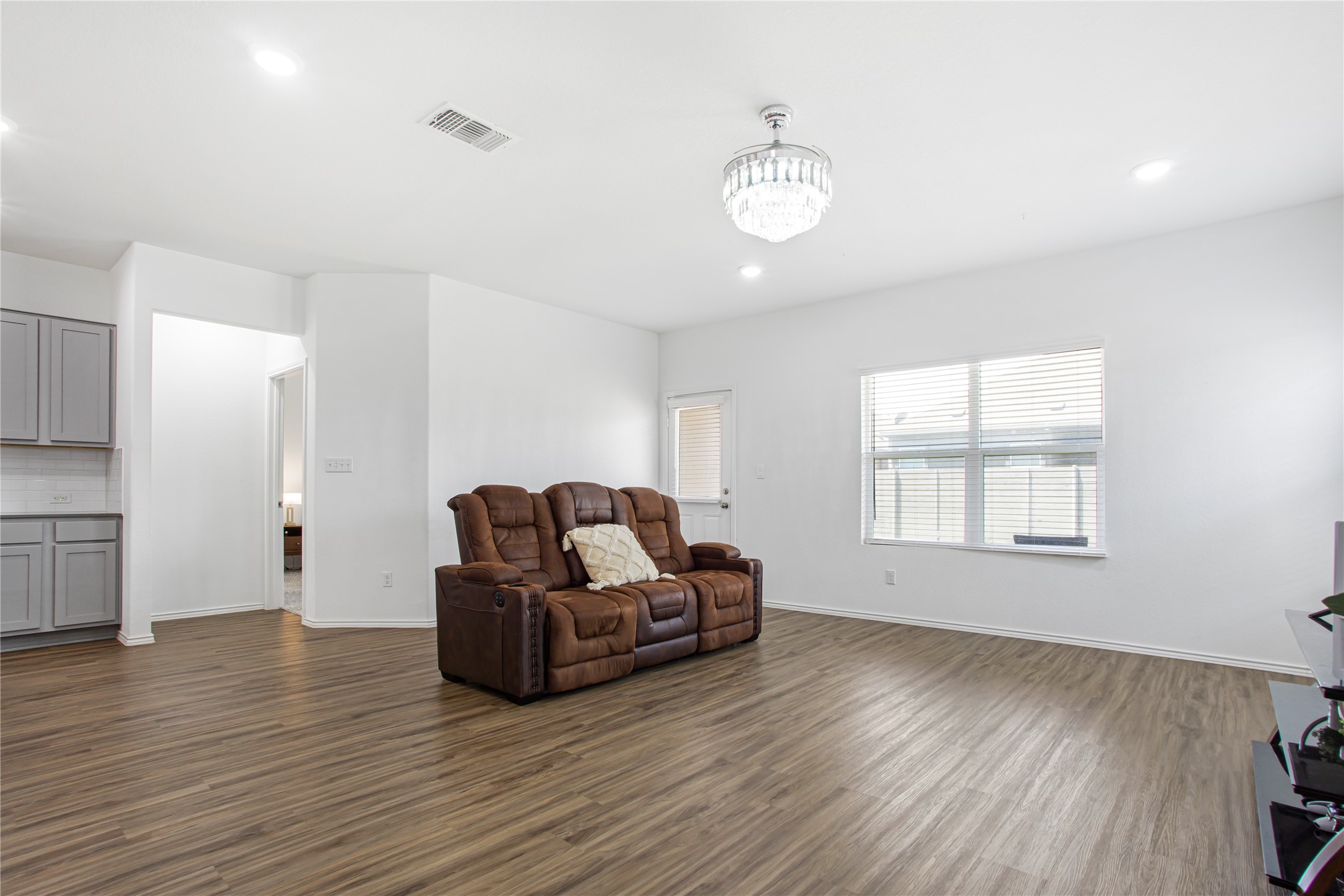124 Cherry Ridge Road Georgetown, TX 78628 - Photo 6 of 23 Spacious living area featuring wood-finish flooring, white walls, and recessed lighting