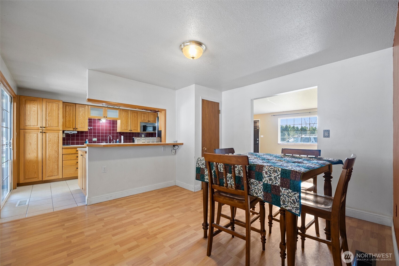 705 North 12th Street Selah, WA 98942 - Photo 11 of 32 a view of a dining room with furniture and wooden floor