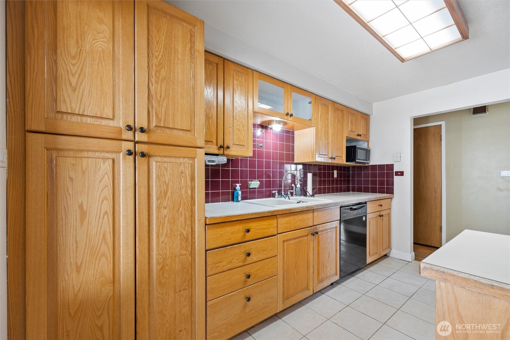 705 North 12th Street Selah, WA 98942 - Photo 15 of 32 a kitchen with stainless steel appliances granite countertop white cabinets sink and dishwasher with wooden floor