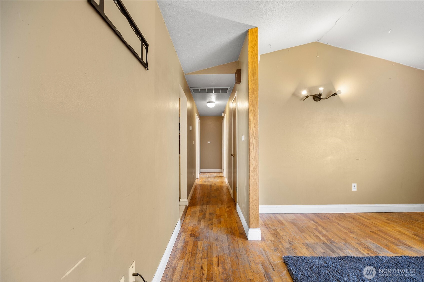 705 North 12th Street Selah, WA 98942 - Photo 19 of 32 a view of a hallway with wooden floor and a bathroom
